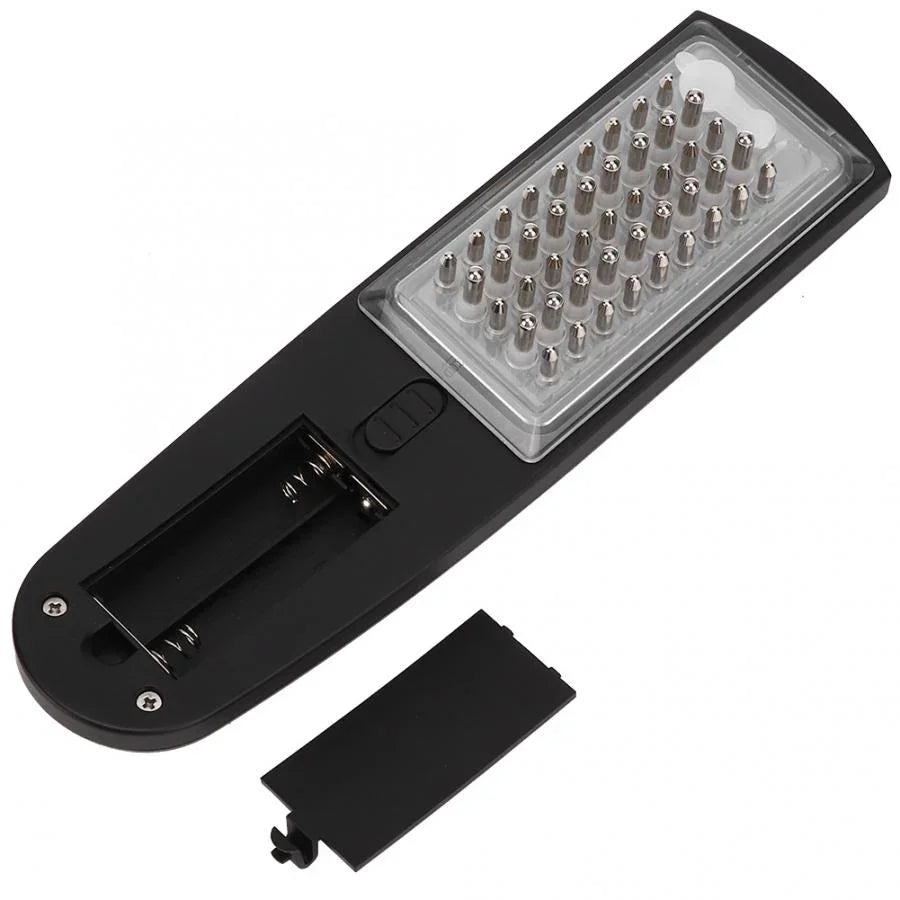 Electric scalp massager hairbrush with metal bristles and open battery compartment