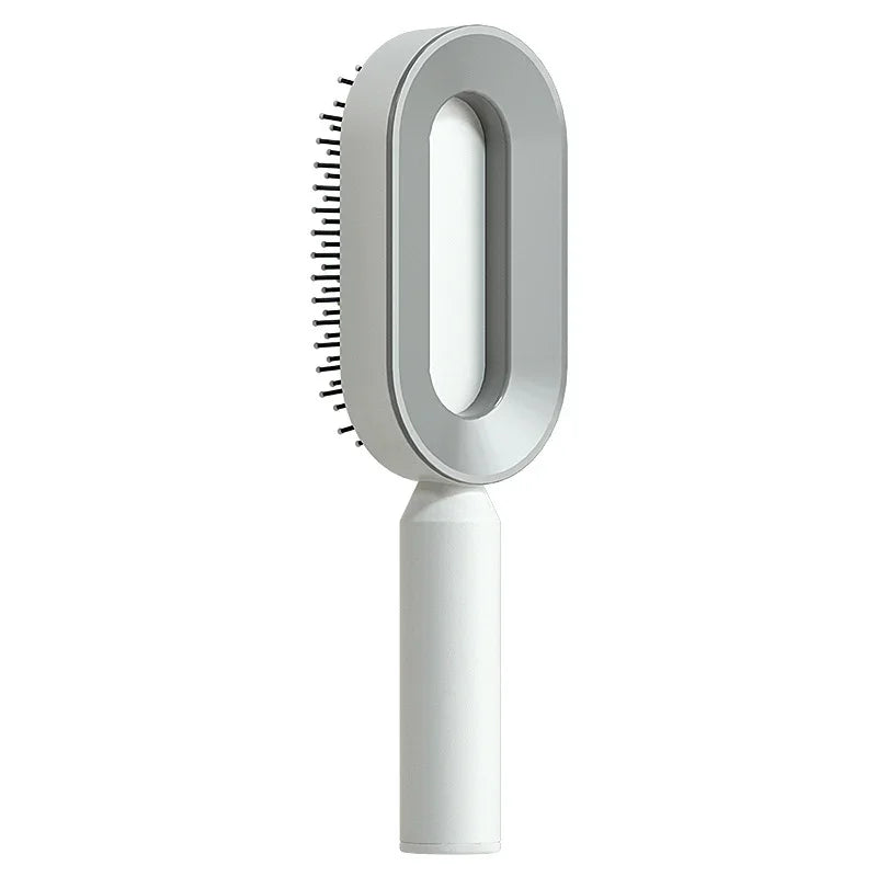 Electric scalp massager hairbrush with oval design and white handle, isolated on white background